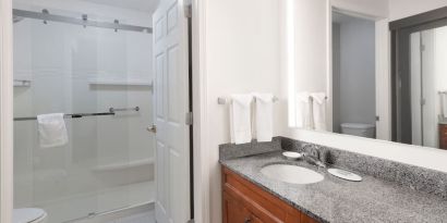 Guest bathroom with shower at Residence Inn By Marriott Bentonville Rogers.