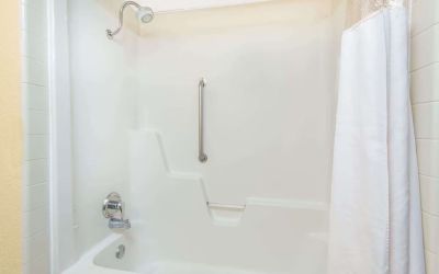 Guest bathroom with shower and tub at Blue Way Inn & Suites Wichita East.