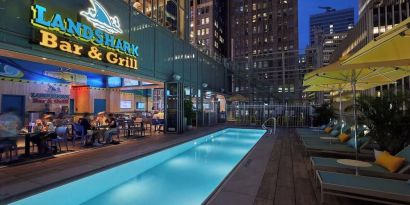 Outdoor pool at night at Margaritaville Resort Times Square.