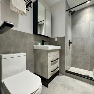 Privte guest bathroom with shower and free toiletries at Rose Hotel, Bronx.