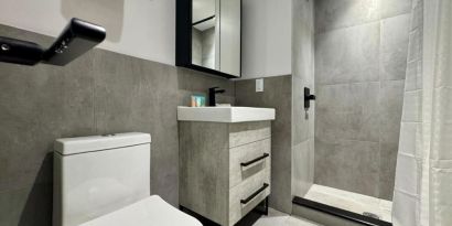 Privte guest bathroom with shower and free toiletries at Rose Hotel, Bronx.