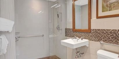 Guest bathroom with shower at Wyndham Garden Chinatown NYC.