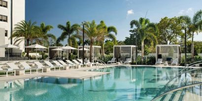 Refreshing outdoor pool surrounded by sun loungers at Renaissance Boca Raton Hotel.
