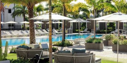 Lounge chairs beside the pool at Renaissance Boca Raton Hotel.

