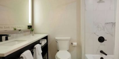 Guest bathroom with shower and tub at Renaissance Boca Raton Hotel.
