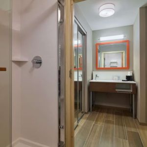Guest bathroom with shower at Hampton Inn & Suites Providence/Smithfield.