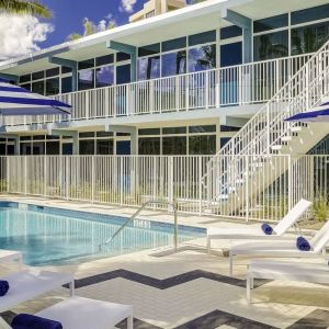 Refreshing outdoor pool and sun loungers at Plunge Beach Resort.