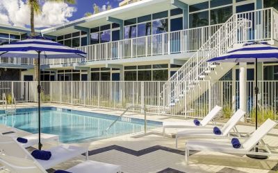 Refreshing outdoor pool and sun loungers at Plunge Beach Resort.