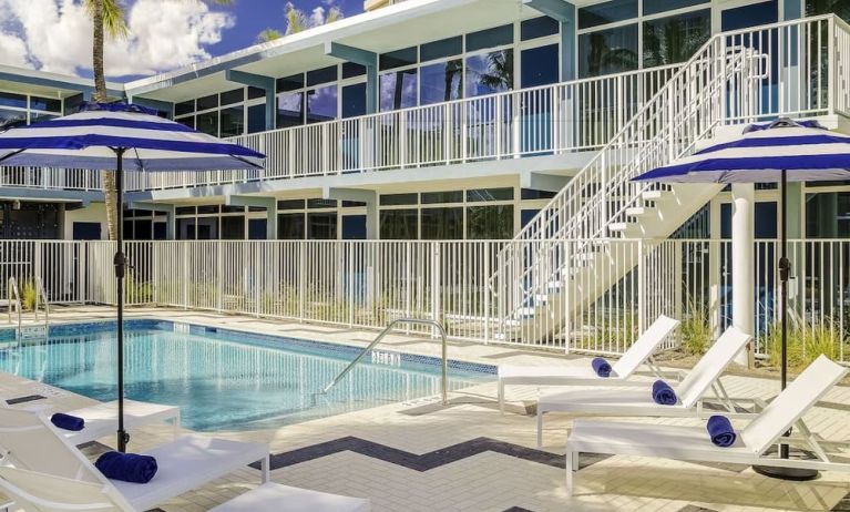 Refreshing outdoor pool and sun loungers at Plunge Beach Resort.