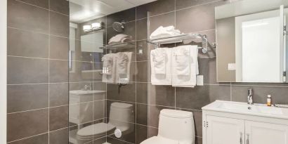 Guest bathroom with shower at Plunge Beach Resort.