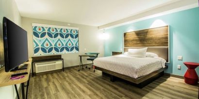 Cozy king-sized bed with TV at Tru By Hilton Bowling Green.