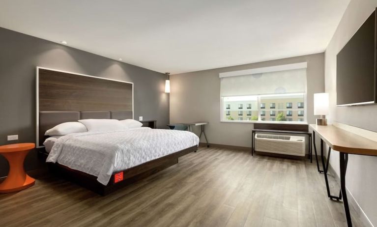 Spacious delux king bed with work desk at Tru By Hilton Wichita Northeast.
