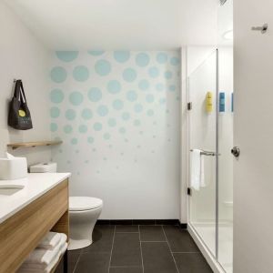 Guest bathroom with shower at Tru By Hilton Wichita Northeast.
