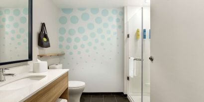 Guest bathroom with shower at Tru By Hilton Wichita Northeast.
