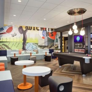 Lobby, coworking lounge and billiards table at Tru By Hilton Wichita Northeast.
