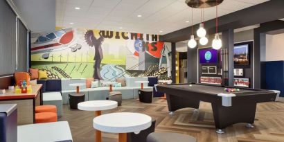 Lobby, coworking lounge and billiards table at Tru By Hilton Wichita Northeast.
