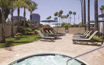 Outdoor pool with lounge chairs at Embassy Suites By Hilton San Diego-La Jolla.