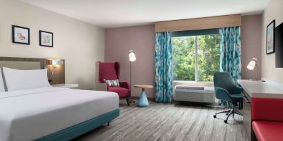 Bright and spacious day use room with work desk and lounge seating at Hilton Garden Inn Kennett Square.