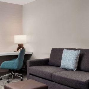 Day use room with workspace and lounge seating at Hilton Garden Inn Kennett Square.