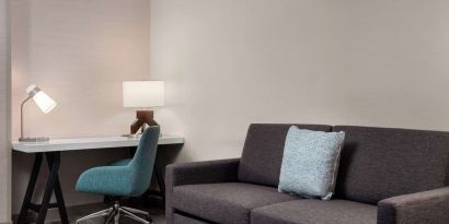 Day use room with workspace and lounge seating at Hilton Garden Inn Kennett Square.