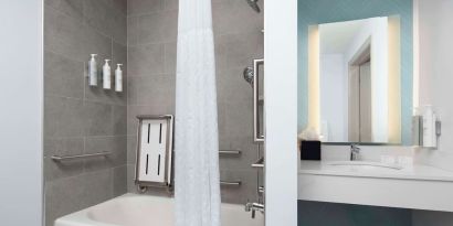 Private guest bathroom with convined tub and shower at Hilton Garden Inn Kennett Square.