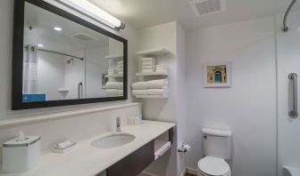 Guest bathroom with shower and tub at Hampton Inn Chicago North/Loyola Station.