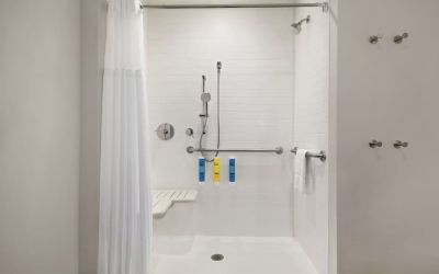 Guest bathroom with shower at Tru By Hilton Milwaukee Brookfield.