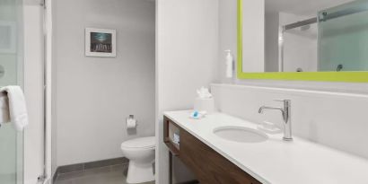 Guest bathroom with shower at Hampton Inn & Suites Phoenix/Gilbert.
