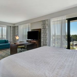 Day use room with work desk, sofa and balcony at Hampton Inn & Suites Sunnyvale Silicon Valley.