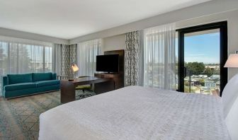 Day use room with work desk, sofa and balcony at Hampton Inn & Suites Sunnyvale Silicon Valley.