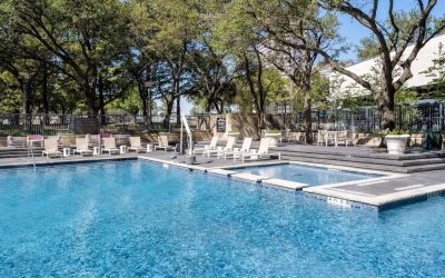 Refreshing outdoor pool surrounded by loungers at Hilton Dallas Lincoln Centre.