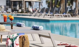 Sun loungers surrounding the pool at Embassy Suites By Hilton Myrtle Beach Oceanfront Resort.