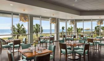 Dining area with natural light perfect for coworking at Embassy Suites By Hilton Myrtle Beach Oceanfront Resort.