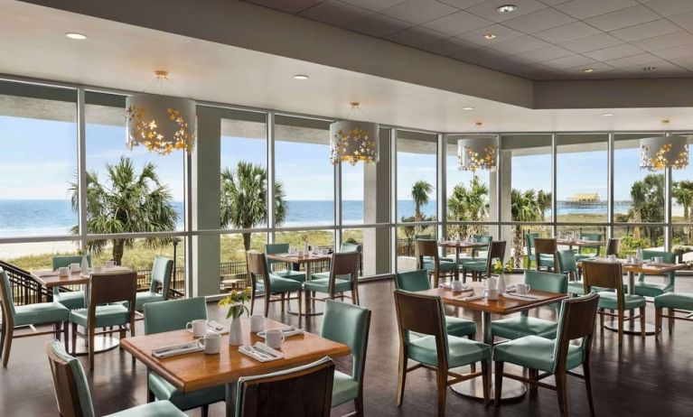 Dining area with natural light perfect for coworking at Embassy Suites By Hilton Myrtle Beach Oceanfront Resort.