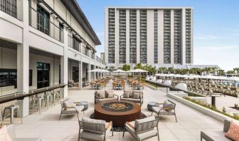 Firepit and plenty of outdoor seats near pool area at Embassy Suites By Hilton Myrtle Beach Oceanfront Resort.