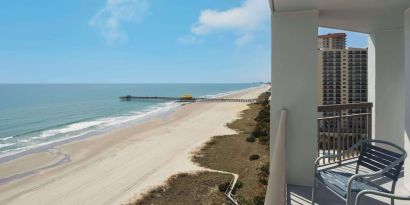 Balcony from day use room overlooking the ocean at Embassy Suites By Hilton Myrtle Beach Oceanfront Resort.