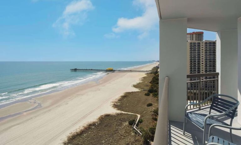 Balcony from day use room overlooking the ocean at Embassy Suites By Hilton Myrtle Beach Oceanfront Resort.