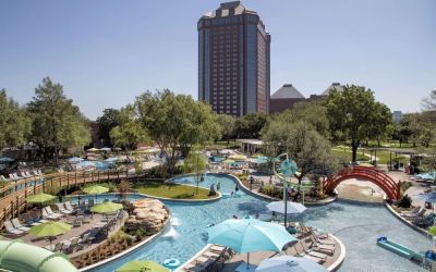 Lazy river, waterslide, and sun loungers available around the outdoor pool at Hilton Anatole.