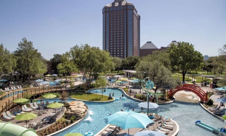 Lazy river, waterslide, and sun loungers available around the outdoor pool at Hilton Anatole.