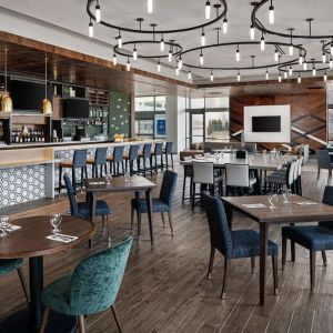 Dining area with natural light perfect for coworking at Hilton Garden Inn Camden Waterfront Philadelphia.
