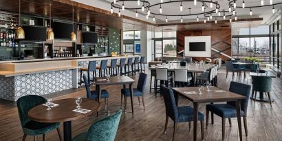 Dining area with natural light perfect for coworking at Hilton Garden Inn Camden Waterfront Philadelphia.