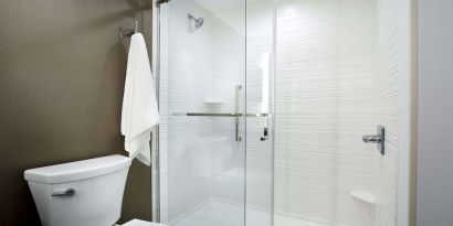 Guest bathroom with shower at Hilton Garden Inn Camden Waterfront Philadelphia.