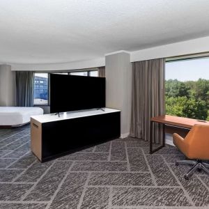 Two queen beds in a spacious day use room with work desk at DoubleTree By Hilton Tulsa - Warren Place.