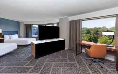 Two queen beds in a spacious day use room with work desk at DoubleTree By Hilton Tulsa - Warren Place.