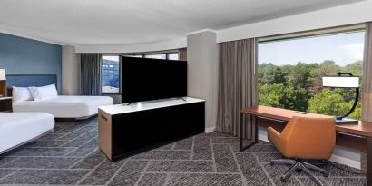 Two queen beds in a spacious day use room with work desk at DoubleTree By Hilton Tulsa - Warren Place.