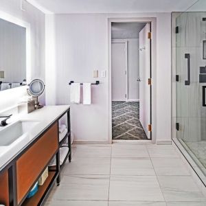 Guest bathroom with shower at DoubleTree By Hilton Tulsa - Warren Place.