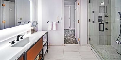 Guest bathroom with shower at DoubleTree By Hilton Tulsa - Warren Place.