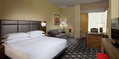 Day use room with work desk and sofa at Hilton Chicago-Northbrook.