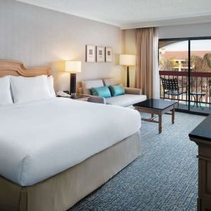 Day use room with work desk, sofa and balcony at DoubleTree By Hilton Sonoma Wine Country.
