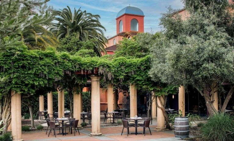 Alfresco dining surrounded by green foliage at DoubleTree By Hilton Sonoma Wine Country.